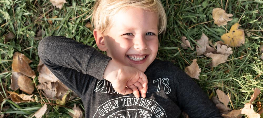 boy in fall leaves